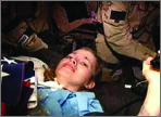 A combat camera image shows an injured Jessica Lynch on a stretcher, surrounded by special operations forces during her rescue from an Iraqi hospital on April 1, 2003.